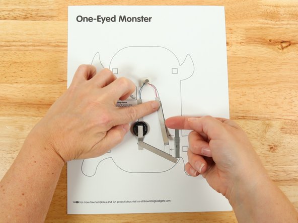 Add tape Path E. pressing it down atop the red wire.
