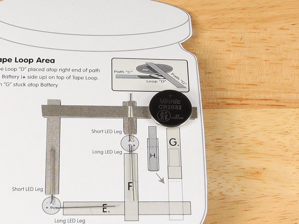 Make sure the Positive side of the Battery is facing upwards, with the Negative side stuck down to the tape.
