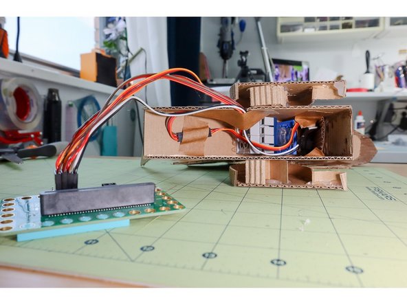 Extend the wires from the servo motor in the neck with an extension cable and double-sided header pins.