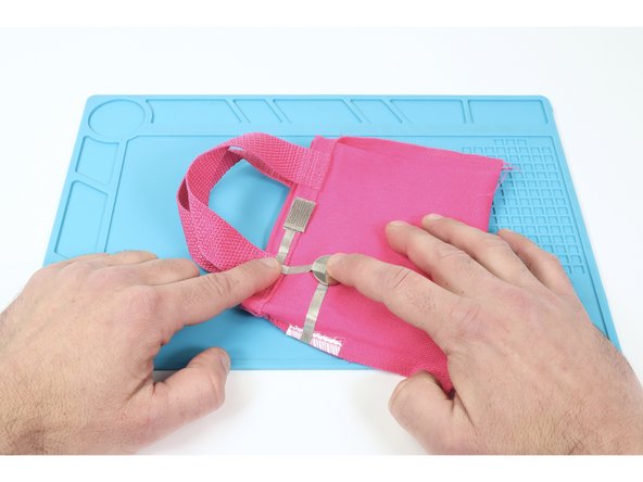 Stick a CR2032 battery positive (+) side UP atop the remaining lower tape loop. Then measure, cut, peel and stick a final Maker Tape path connecting the top of the battery to the Maker Tape path above the battery as shown.