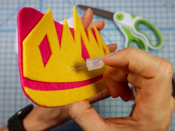 Insert each LED through the holes with the longer, positive leg in the top hole.