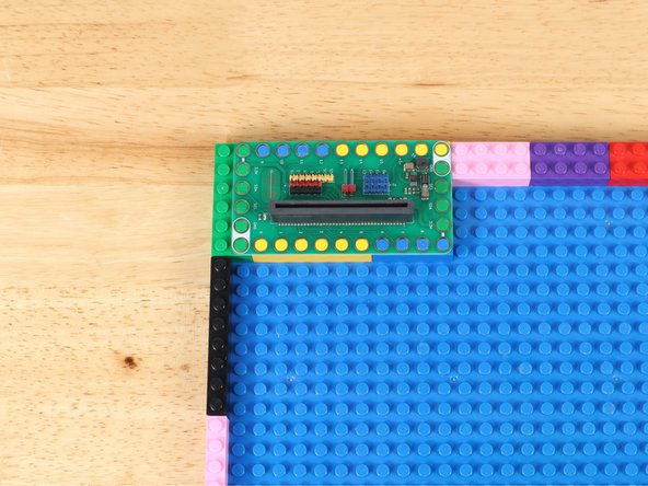 Arrange LEGO bricks in one corner to support a Crazy Circuits Bit Board.