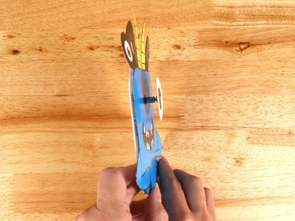 Add another square of double-sided tape onto the shaft of the motor, and then stick the eye to it.