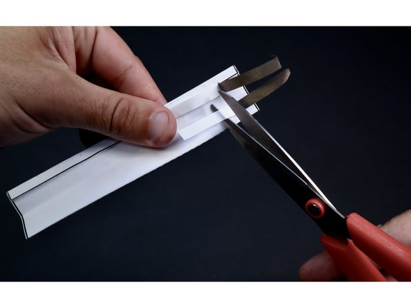 On the side of the template without markings, peel/cut the backing back to the slit on both pieces of Maker Tape.