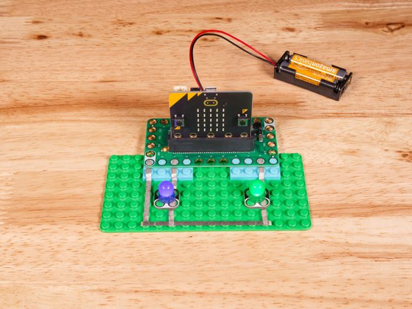 Connect the Negative (-) sides of the LEDs to a Ground (GND) hole on the Bit Board.