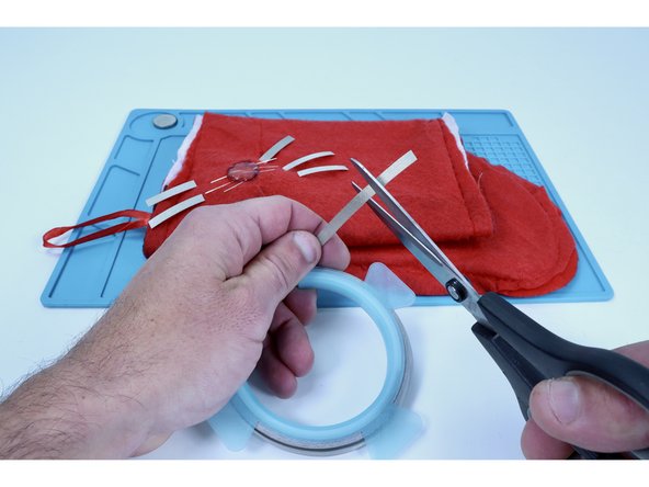 Measure and cut 6  pieces of Maker Tape that are approximately double the remaining exposed length of the LED legs.