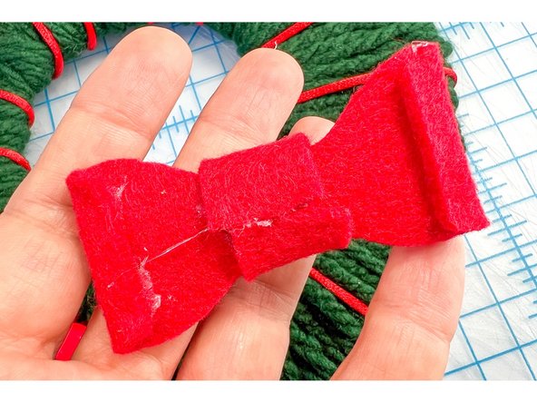 Then, I used the template to make a felt bow, hot gluing it together and then gluing it to the wreath.