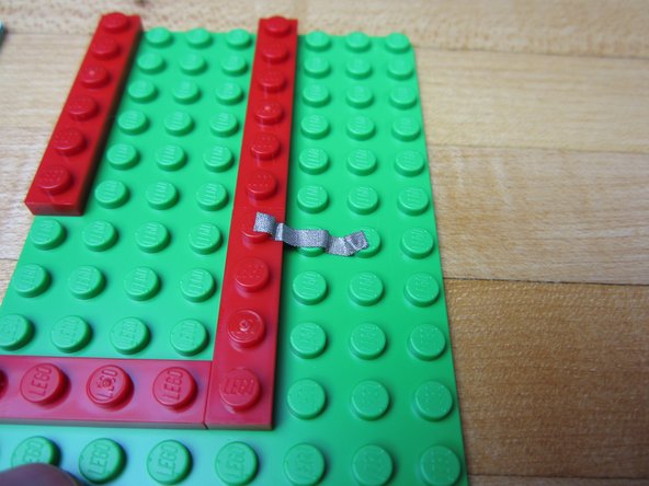 Run Maker Tape from Pin 16 to where you want your Piezo Speaker. Cut excess tape and press down with your fingernail or the Piezo Speaker.