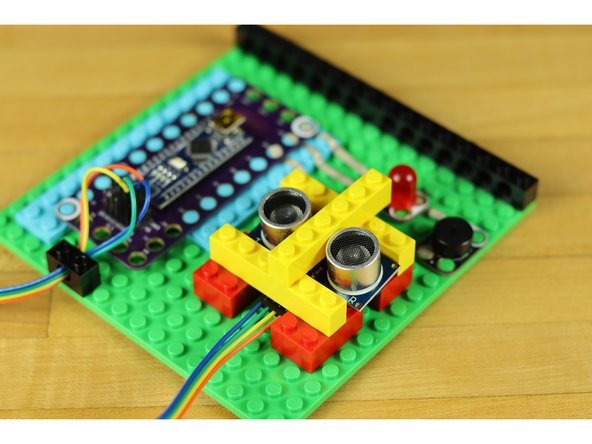 Use some additional LEGO bricks to secure the range finder in place.