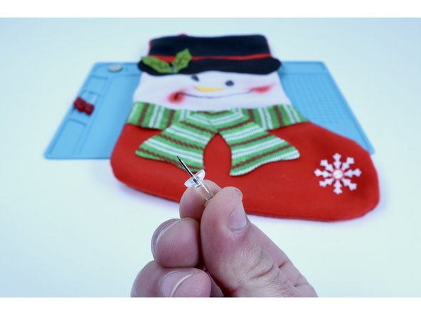 These accents are almost always held on by blobs of hot glue and may have several layers of material below THAT. For these reasons, use a push pin to make to make two &quot;pilot holes&quot; for each LED (6 TOTAL) through the material  where each accent was for the LED legs to be threaded through in the next step.