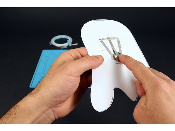 Peel and stick the longer piece of Maker Tape so that it contacts path &quot;B&quot; on one end and the top of the battery on the other end. This will turn your LEDs on! Simply peel back to turn them off.