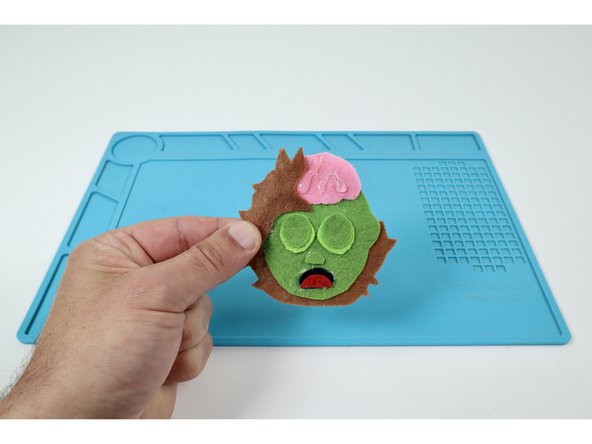 Add a squiggle of hot glue to finish off the brain! Dont touch it until it's fully hardened to allow it to maintain the shape.