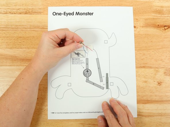 Stick the motor to the double sided tape making sure the back of the motor (with the wires) is stuck down to the tape and the part that spins faces upwards so it can move freely.