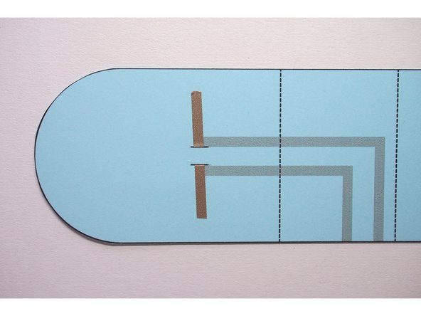 Repeat with the other slit so there are two pieces of Maker Tape