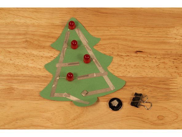 While the binder clip works great to hold the batter in place, we can also use two loops of Maker Tape to turn our circuit on.