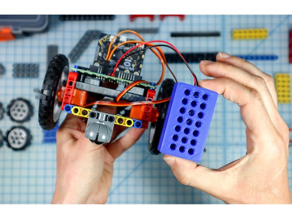 Remove the battery pack from the back of the Rover making sure to also remove the black pegs that held it in place.