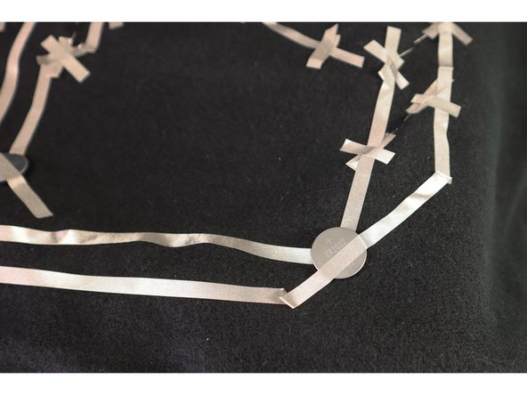 In this circuit, the battery is placed in the middle and the LEDs are to the left and right. This made it easier to lay out, but we had to be careful that the positive and negative pieces of Maker Tape didn't touch!
