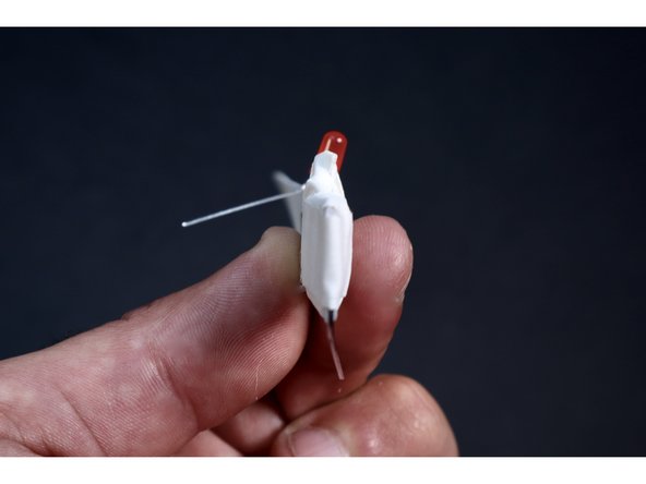 With another small piece of gaff/duct tape, wrap ACROSS the paperclip. This is an important area to strengthen because this paperclip is part of the launching apparatus and will be under rubber band tension while in the process of being flung.