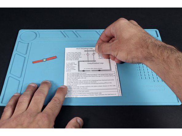 Using a thumbtack or push pin, poke holes where shown, using the 4 small dots as a guide.