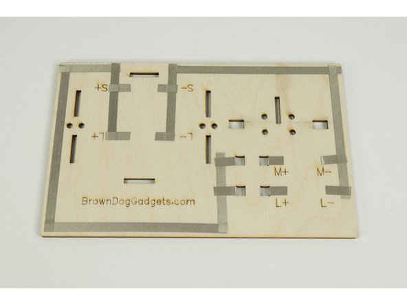 Wrap the tape around to the back side of the base as shown.