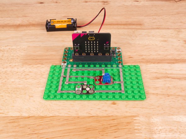 We'll connect our Potentiometer to Pin 1, Ground (GND), and 3.3v BUT! We're going to use the &quot;gutter&quot; between the LEGO baseplate studs so we can have two layers of tape that do not touch.