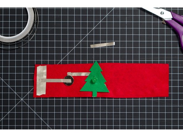 With the slit over the LED, press the Christmas Tree in place. It should fit over the LED and be held in place right behind the plastic housing of the LED.