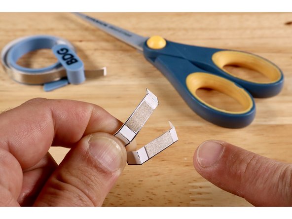 Fold on the 4 dotted lines as shown.