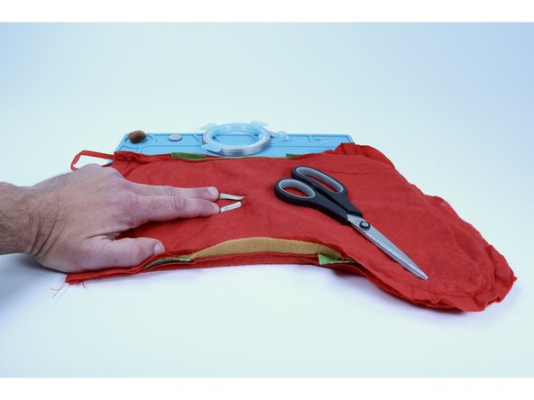 Now use the remaining two Maker Tape segments on the opposite side of the ones you just placed (sticky to sticky) so as to sandwich each LED leg between the tape.