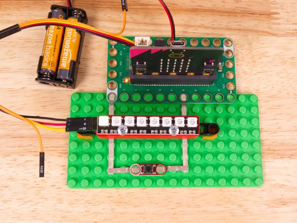Use the Crazy Circuits Ribbon Cable to connect the NeoPixel Strip to the Bit Board.
