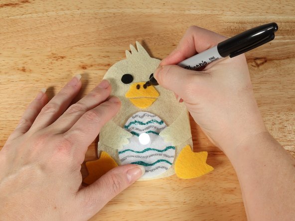 If you are using Elmers or Tacky glue, you will need to use something to hold the wings in place until it dries. Binder clips work well for this.