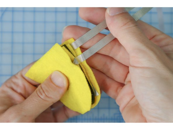 It's important that the two long pieces of Maker Tape exit the sensor on the same side, but do not touch each other.