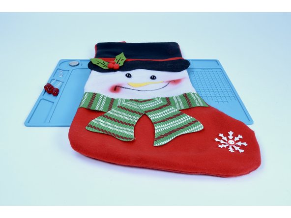 Oftentimes a stocking may have other clusters of accents that could be replaced by LEDs.  At this point, things can get a little more intensive. Use the strategies found in this guide for 3-4 LEDs. In our project, we are going to swap the 3 holly berries on the snowman's hat with 3  jumbo red 10mm LEDs.