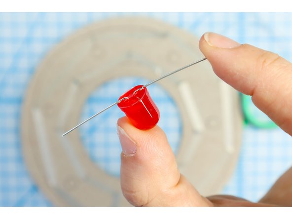 The LEDs have a long positive leg and a short negative leg. Note which is which and bend the LED's legs flat as shown.