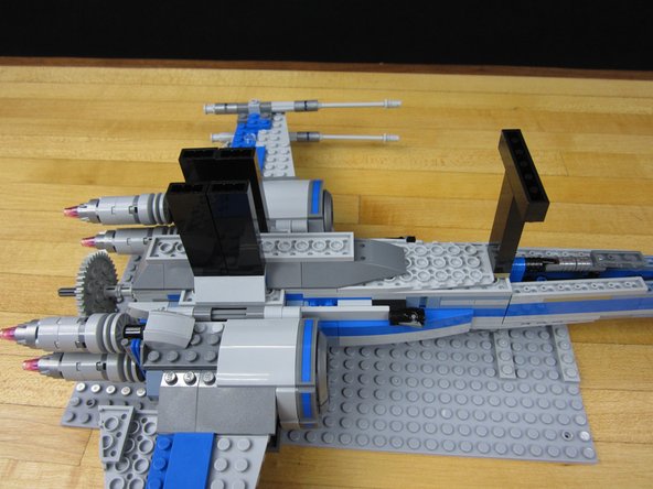 We used some tall 1x2x5 bricks (2454) to make supports. You can use whatever you want provided that it gives enough clearance for the wings and Servo.