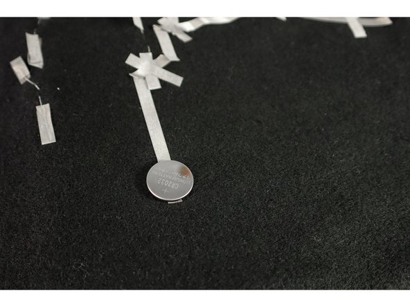 Stick the battery to the long piece of Maker Tape as shown.