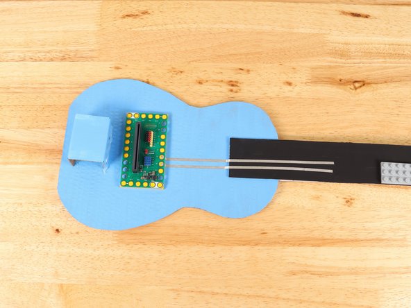 Using 1/8" Maker Tape, adhere the end of the Maker Tape to the center of the stud underneath Pin 14 of the Bit Board.