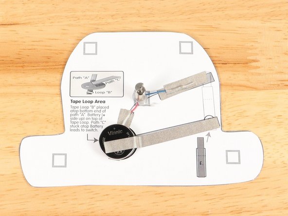 Add another piece of Maker Tape to  Tape Path D. pressing it down atop the blue wire.