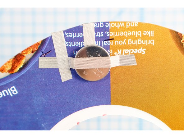 Place another piece of Maker Tape over the battery and touch the positive side.