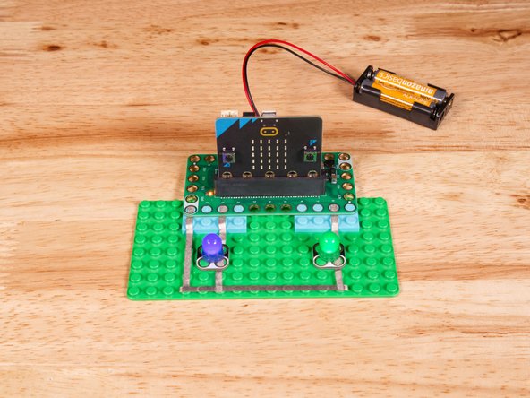 Connect the Negative (-) sides of the LEDs to a Ground (GND) hole on the Bit Board.