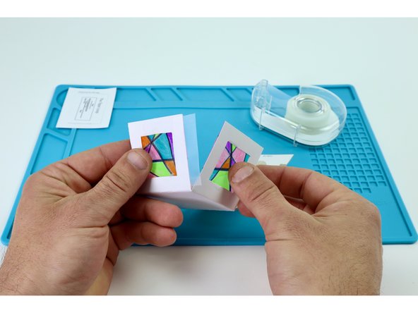 Using tape segments that are the same length as each seam; Lay half of each piece's width on one frame. Bring the neighboring side up to match the edges. Press the remaining part of the tape's width to that next frame.