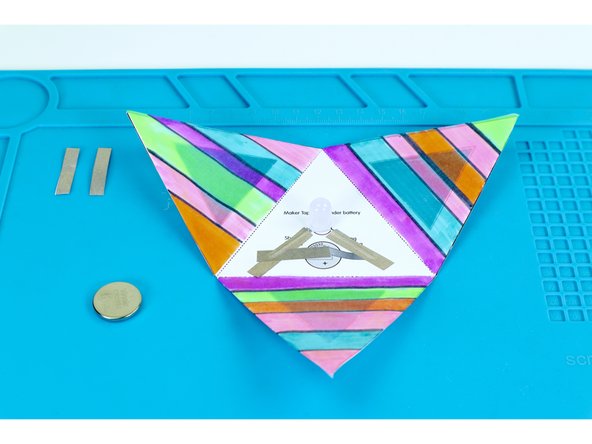 Peel and stick the paths shown in photo 1. This should leave you with two sections of Maker Tape.