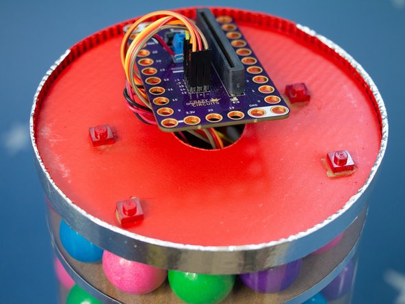 We added the gumballs one at a time to allow them to travel around the track and get trapped by the LEGO piece.