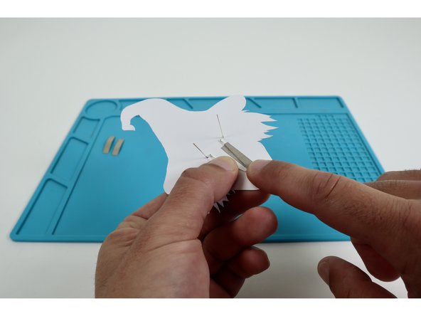 Peel and stick one of your three Maker Tape pieces atop one of the long legs and onto the paper below it.