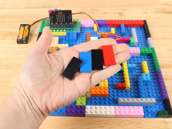 If you want to create a smoother pathway that the ball doesn't get stuck on, you can use LEGO tiles to line the base of your pathway.