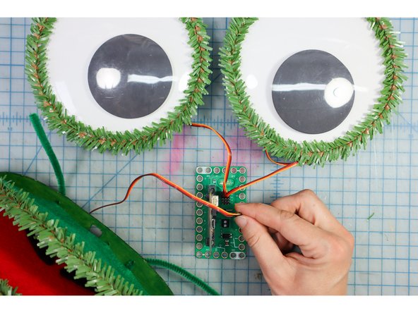 Connect the servo motors in the eyes to Pin 13 and Pin 14 using the pins on the back of the bit board. The brown wire is ground (-).