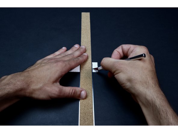 With proper supervision, use a ruler and an Exacto Knife to cut the two small corresponding slits shown in the photos at left. Make multiple passes with the blade and take care to only cut the length of line/slit on the template. You will thread two small sections of Maker Tape through these slits in the coming steps. 