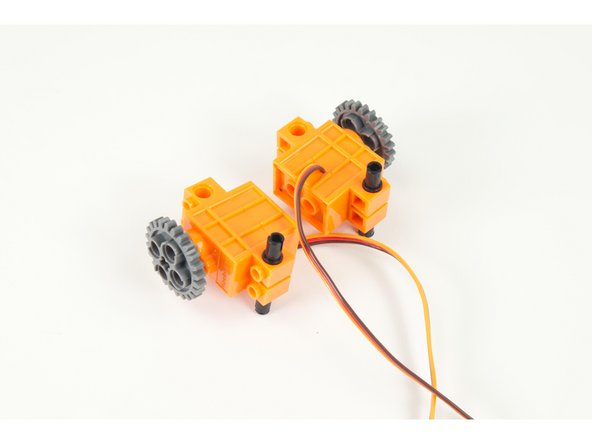 Add the large gears to the servo shafts.