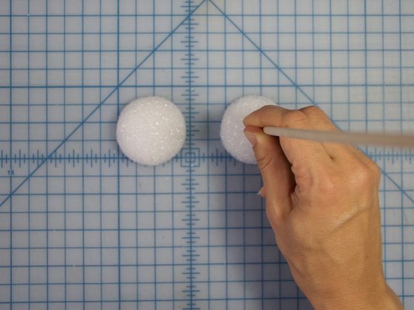Use a dowel or another type of round stick (like a pencil) to make a hole in the center of each eye.