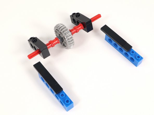 Add the bricks with holes to each side of the axle. The axle should go through the very last hole under the 1x4 tile.