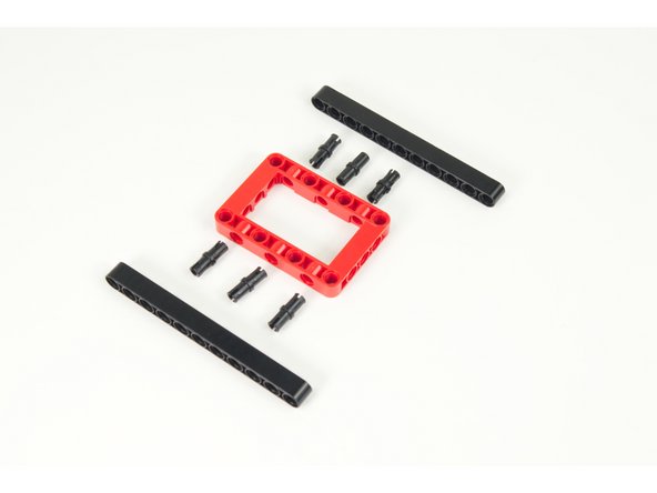 We'll start with one of the frame pieces, 6 pins, and two long 11 hole beams.